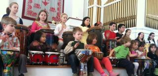 A youth choir, drumming.